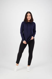 A woman smiles against a white background, wearing a navy blue hoodie with Vassalli Fortune Pant in black and white sneakers for a casual, pull-on style.