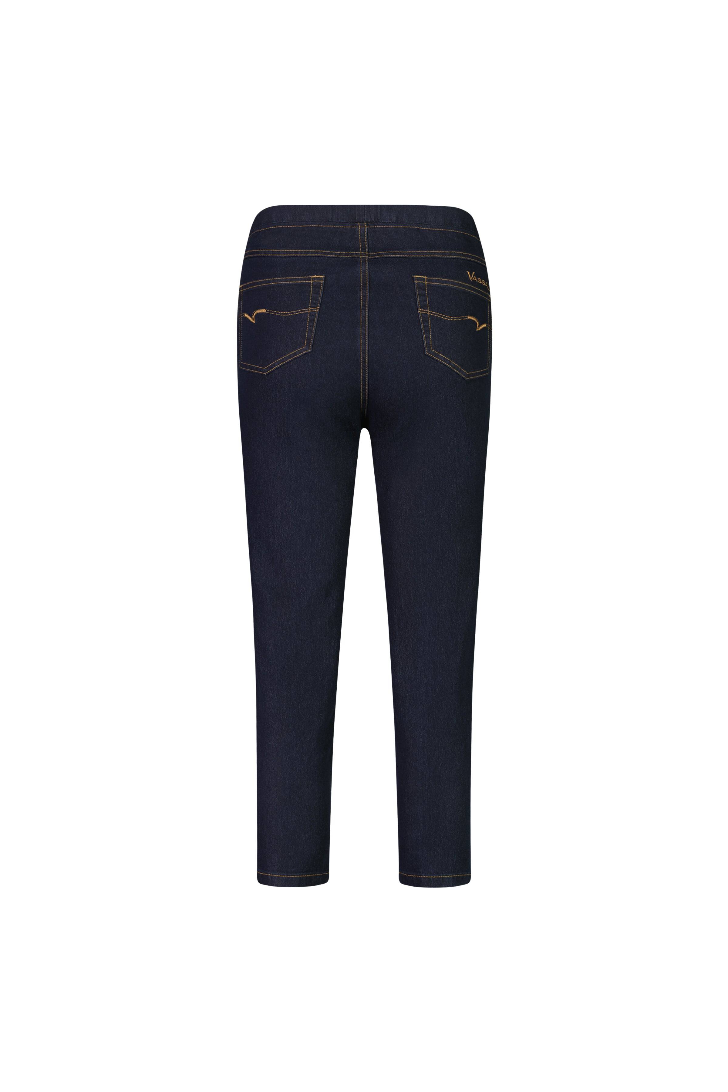 Back view of the Vassalli Harbour 7/8 Pant in Indigo Denim (Contrast Stitch), featuring two back pockets with decorative stitching and orange contrast seams, displayed on a white background.