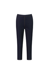 The Vassalli Harbour 7/8 Pant in Indigo Denim (Contrast Stitch) is a dark blue pull-on style with an elastic waistband, brown contrast stitching, and a slim, ankle-length fit reminiscent of classic skinny jeans. Shown from the front on a white background.