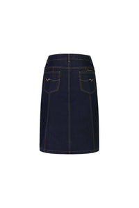 The Vassalli Poppy Skirt in indigo denim is shown from the back, with two rear pockets, contrast stitching, and a waistband with belt loops, set against a white background.