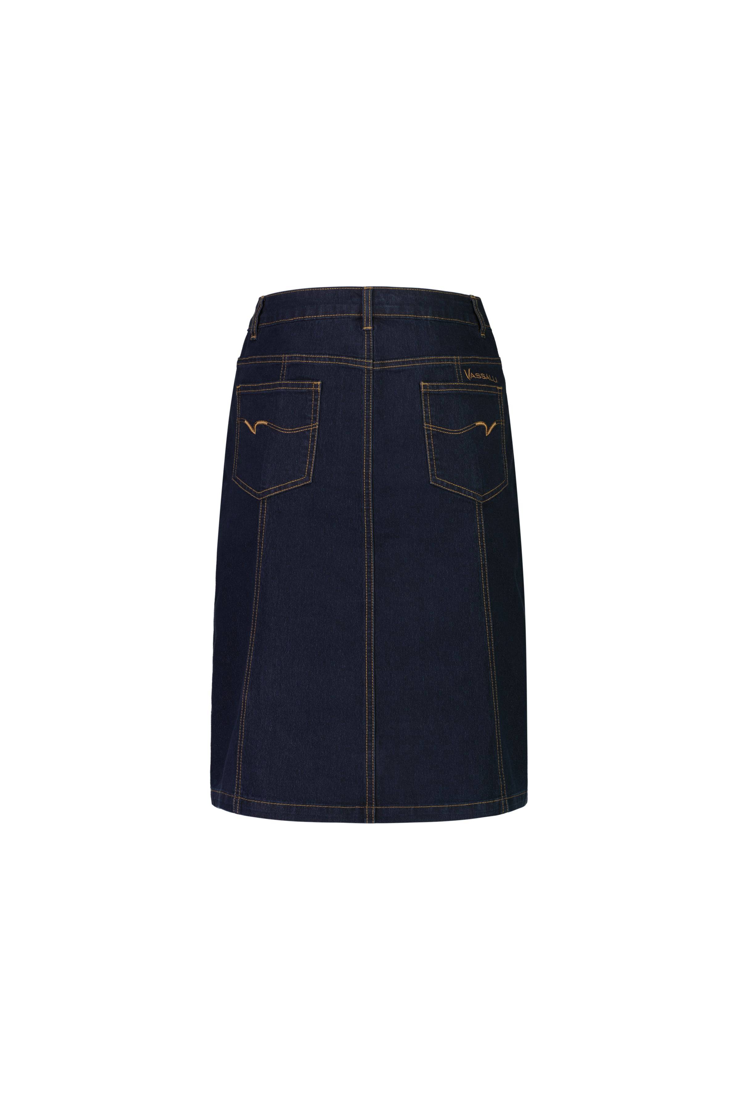 The Vassalli Poppy Skirt in indigo denim is shown from the back, with two rear pockets, contrast stitching, and a waistband with belt loops, set against a white background.