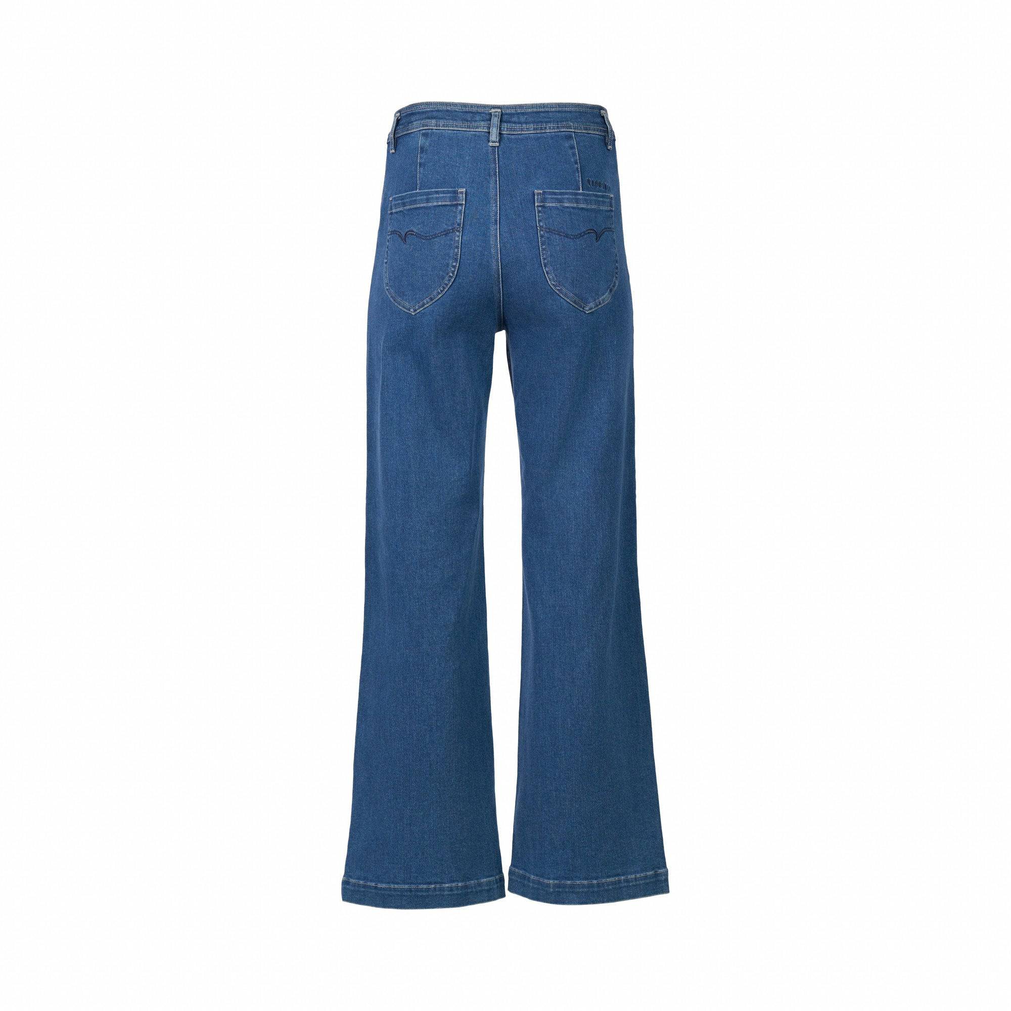 Back view of Vassalli Peace Jean - Blue Wash, featuring a wide leg, two back pockets, and visible stitching in blue stretch fabric, displayed against a plain white background.