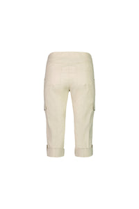 The Vassalli Wave Pant in Sand is a light beige, below-knee cargo style made from stretch poplin. It features a pull-on waistband, side and back pockets, and adjustable cuff straps. Shown from the back against a white background.