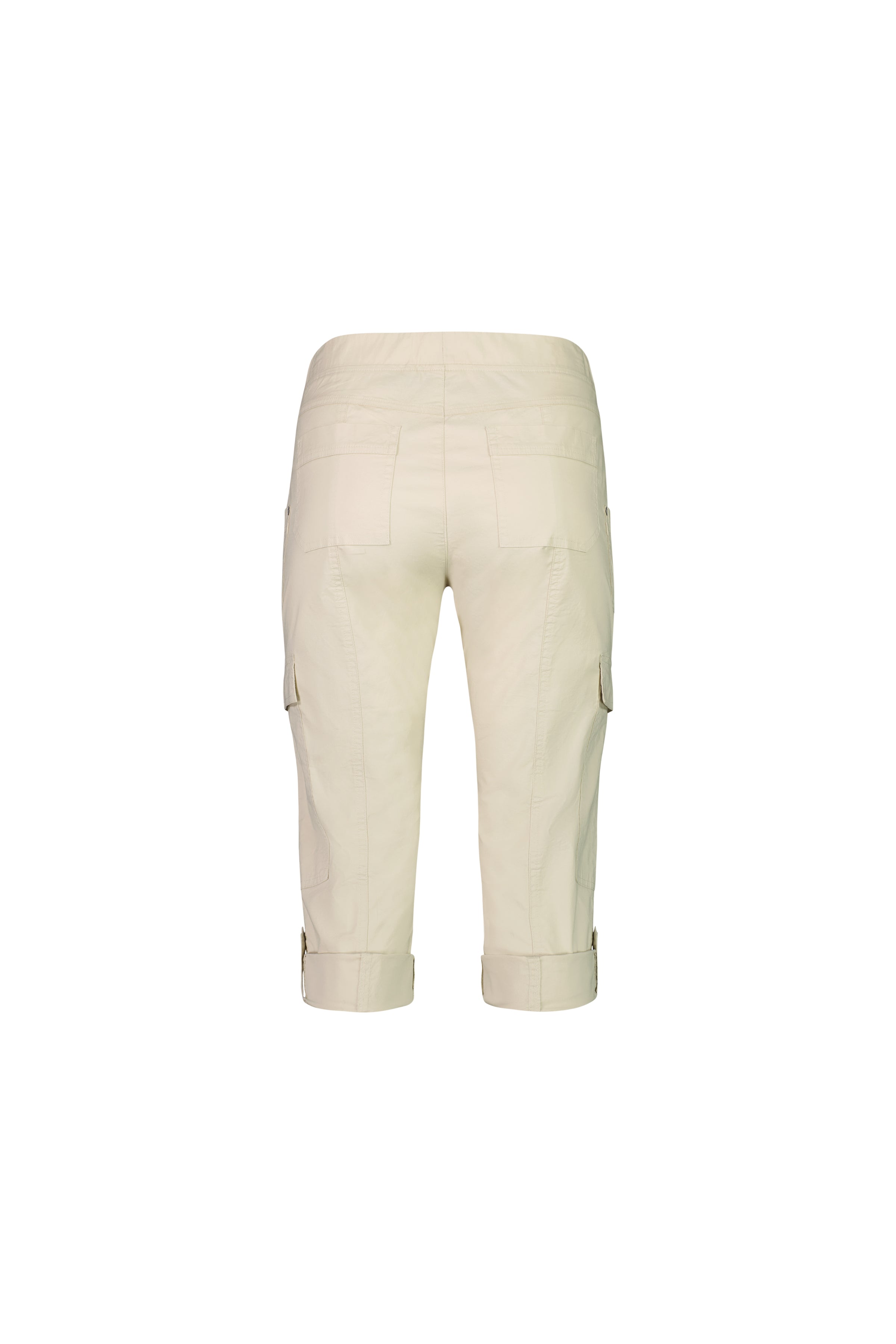The Vassalli Wave Pant in Sand is a light beige, below-knee cargo style made from stretch poplin. It features a pull-on waistband, side and back pockets, and adjustable cuff straps. Shown from the back against a white background.
