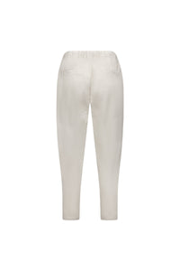 Back view of the Vassalli Denver 7/8 Pant in Stone, an off-white, ankle-length cotton blend with elastic waistband, two welt pockets, skinny leg, relaxed fit and a minimalist design.