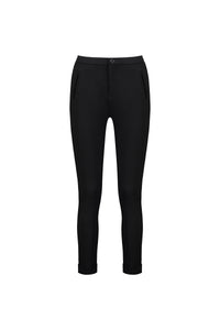 The Vassalli Style Pant - Black features a slim-fit, full-length ponti design with front zipper pockets and buttoned cuffs, made from stretch fabric for comfort. Shown against a plain white background.