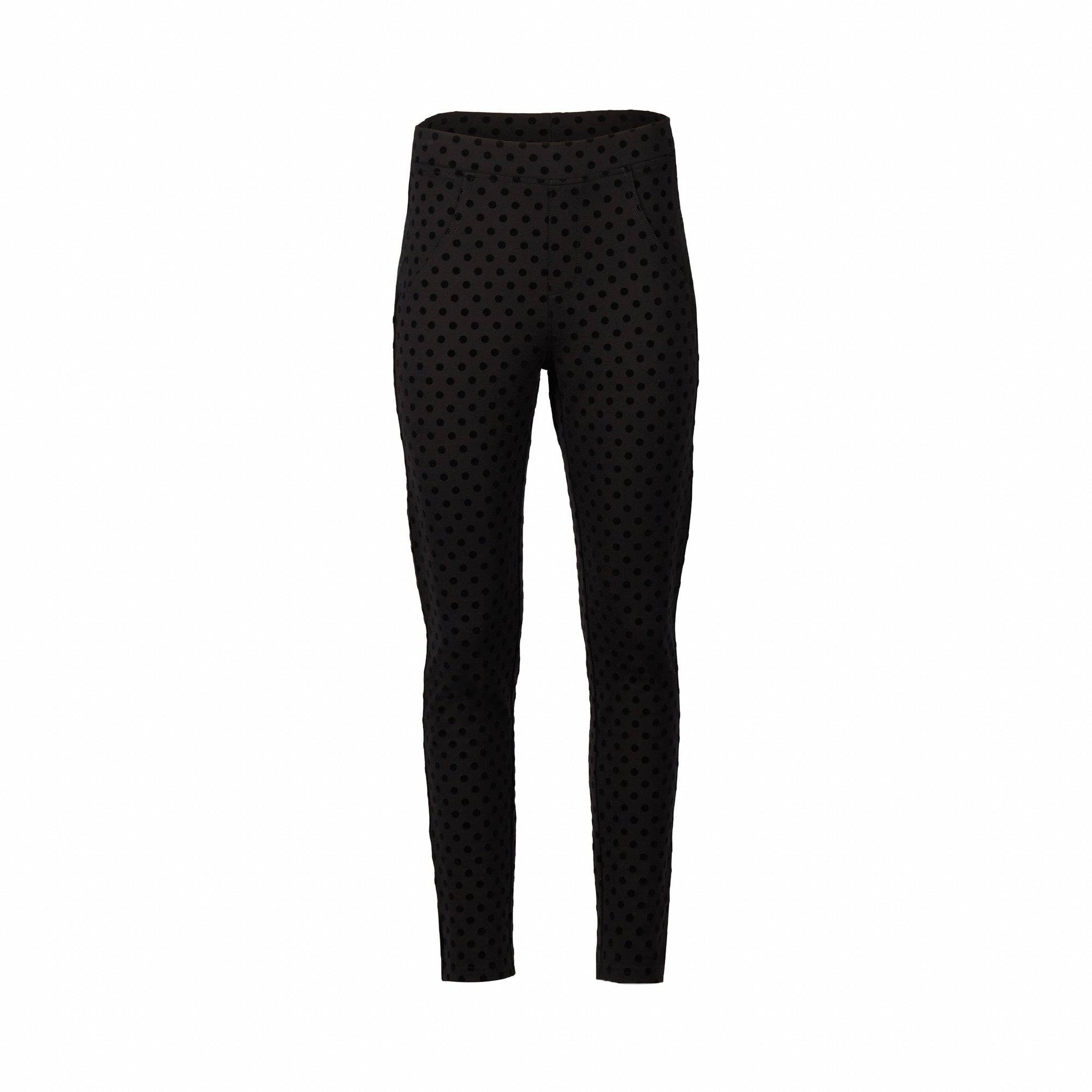 The Vassalli View Pant - Black features a high waist, stretch fabric, skinny leg ankle grazer cut, and a subtle small polka dot pattern, shown on a plain white background.