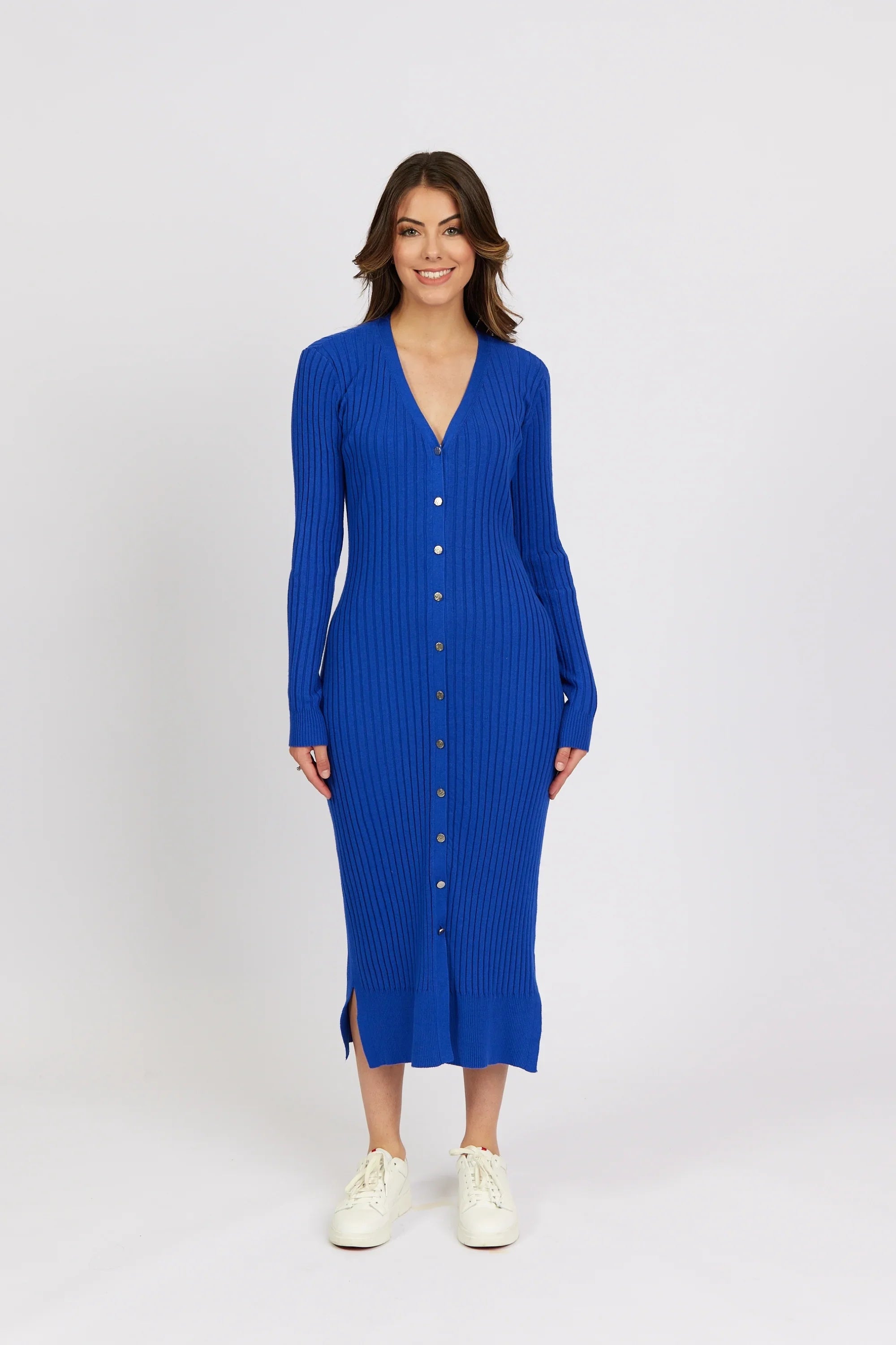 Woman wearing a ribbed electric blue button-down knit midi dress with long sleeves
