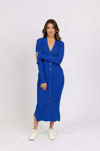 Woman wearing a ribbed electric blue button-down knit dress with long sleeves and white sneakers