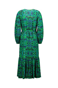 Back view of a long-sleeve green and blue geometric print midi dress with ruffle hem