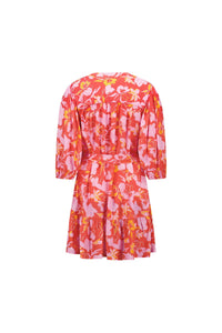 Back view of a short floral print dress with pink, yellow, and orange patterns and puff sleeves.