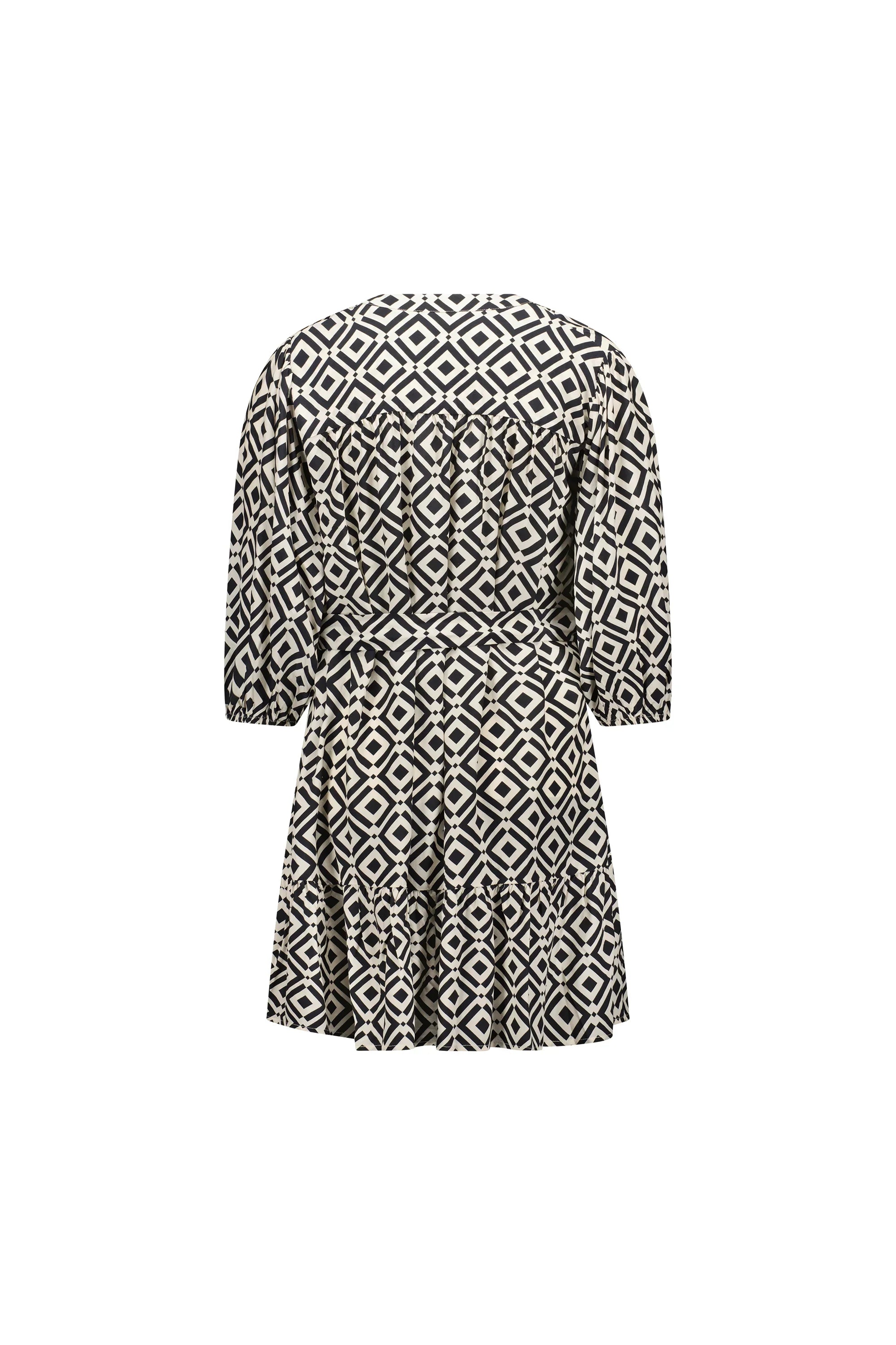 Back view of a black and white geometric patterned short dress with half sleeves