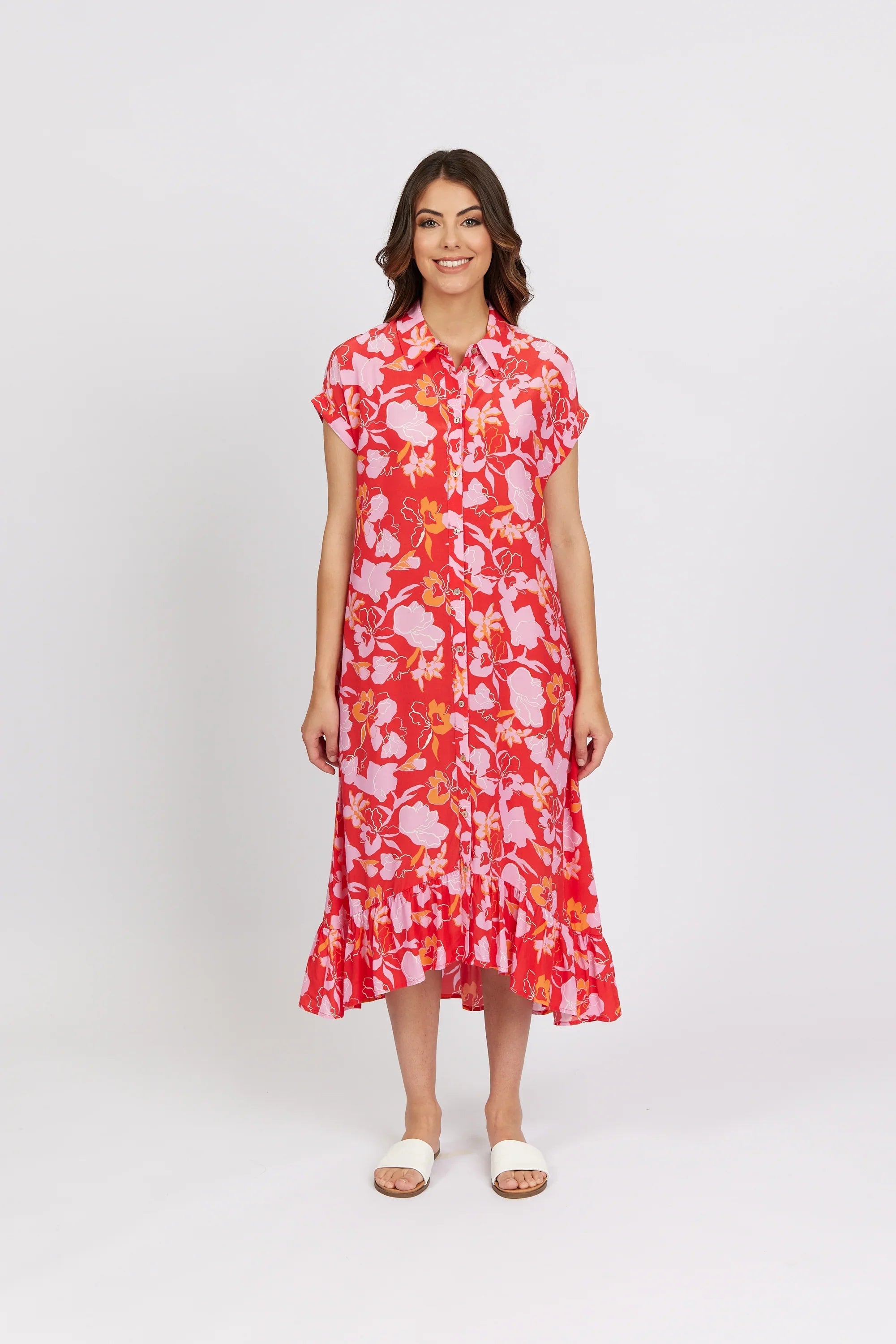Woman wearing pink and red floral button-up midi dress with short sleeves and ruffle hem.