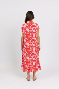 Back view of woman wearing a red floral midi dress with short sleeves and ruffle hem