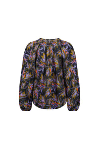Back view of long sleeve women's blouse with vibrant floral print in purple, orange, and yellow