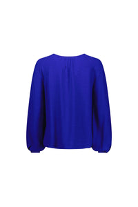 Back view of electric blue long sleeve women's top with relaxed fit and gathered neckline