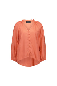 Coral long sleeve blouse with button front and ruffle collar, relaxed fit, on white background