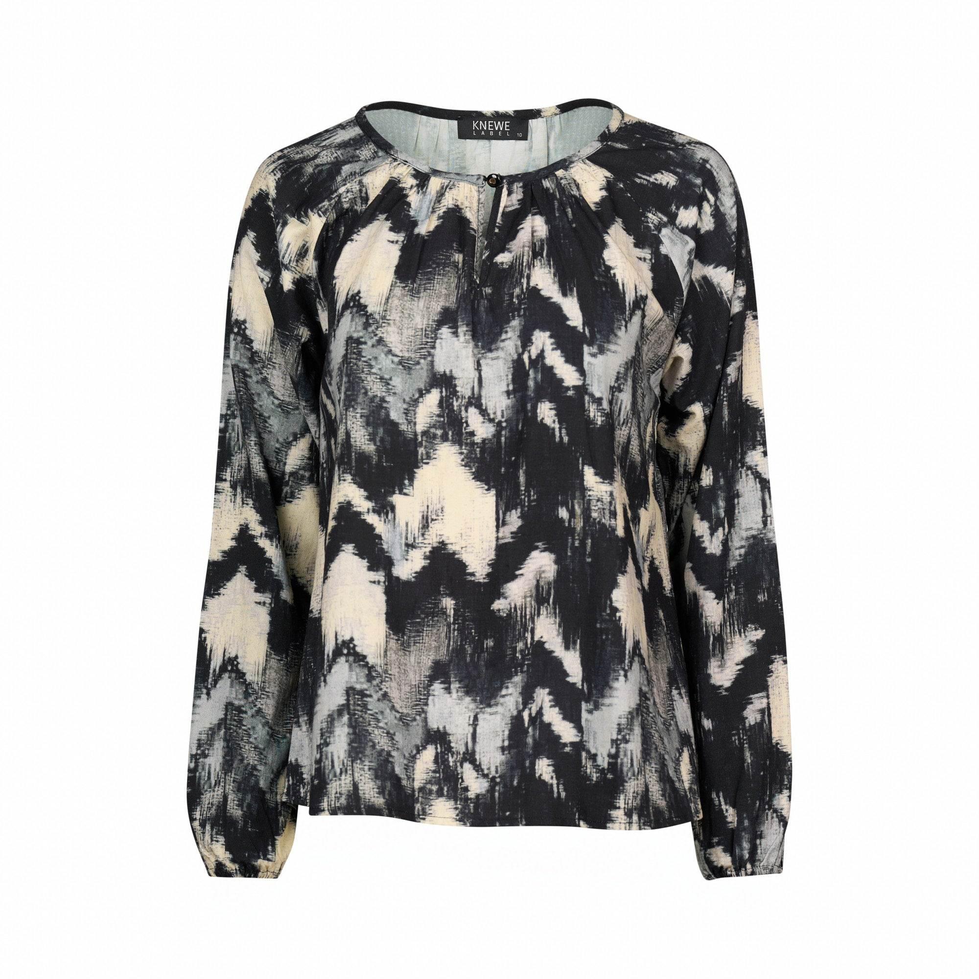 Long sleeve blouse with abstract black, white, and beige print, round neckline.