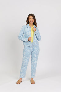 Woman wearing light blue denim jacket and jeans with white heart patterns, yellow top