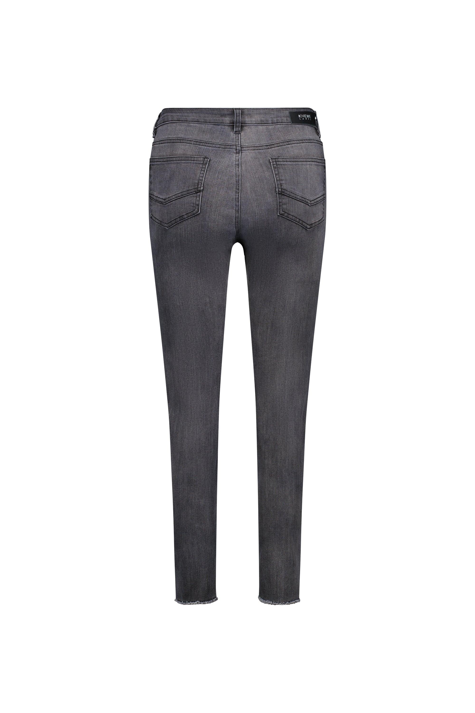 Back view of space grey skinny jeans with two rear pockets and raw hem on white background