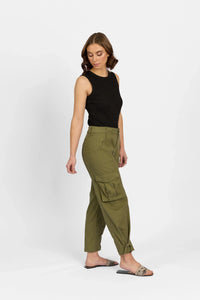 Woman wearing khaki cargo pants with pockets and a black sleeveless top, standing sideways