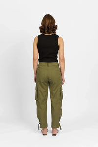 Woman wearing khaki cargo pants with side pockets, black sleeveless top, rear view