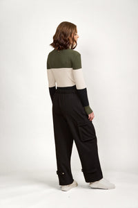 Woman wearing black cargo pants with side pockets and cuff details, casual style