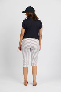 A person stands facing away, wearing a black cap, black short-sleeve shirt, and Vassalli Paris Printed Short in white with stripes, plus flip-flops, against a plain white background.