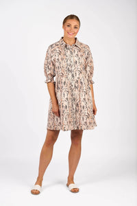 Woman wearing a knee-length, pink and black animal print dress with short sleeves