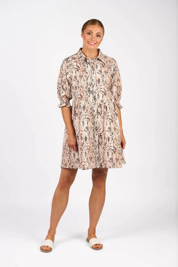 Woman wearing a knee-length, pink and black animal print dress with short sleeves