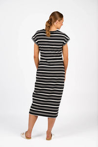 Woman wearing a black and white striped midi dress with short sleeves, back view